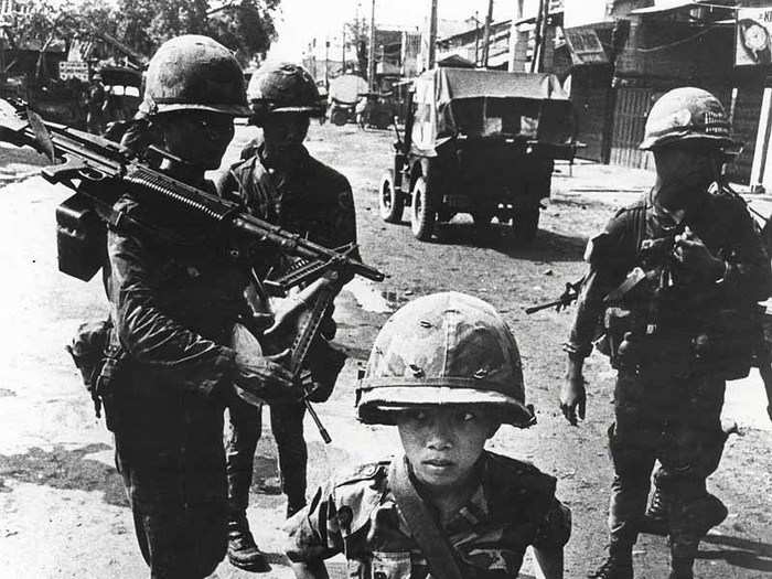 "Little Tiger," a child soldier rumored to have killed his mother and his teacher, stands for a photograph in 1968.