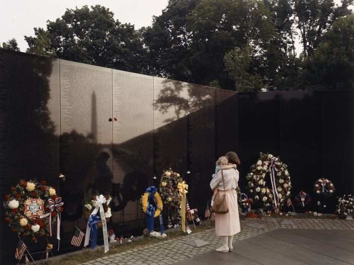 A woman and child visit the Vietnam Veterans Memorial in Washington, D. C., 1986. The wall, which features the names of all those killed or missing in action, was completed in 1982.