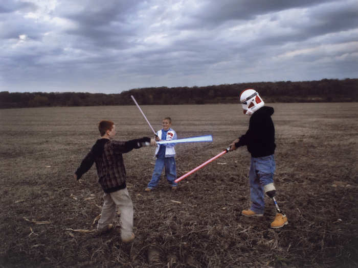 Raymond Hubbard, an Iraq War veteran with a prosthetic leg, puts on a Star Wars stormtrooper’s helmet and engages his sons in a light-saber battle in 2007. His father was similarly injured in Vietnam.