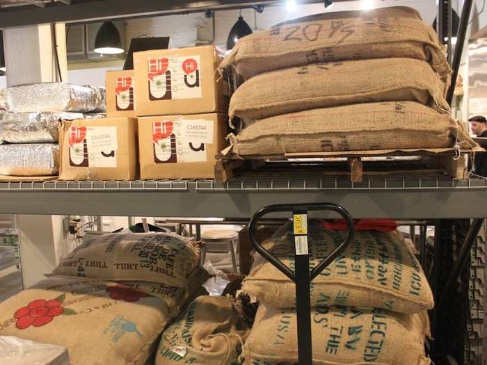 Sacks of coffee beans sit on shelves in the back. The staff explained that they roast small batches at a time, equivalent to about half of one of these bags.