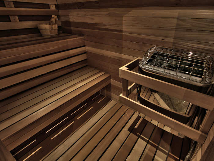 A dry sauna is hidden behind a two-way mirror door next to her walk-in closet.