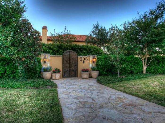 This is the really fancy gate in front of the house surrounded by perfectly trimmed shrubbery.