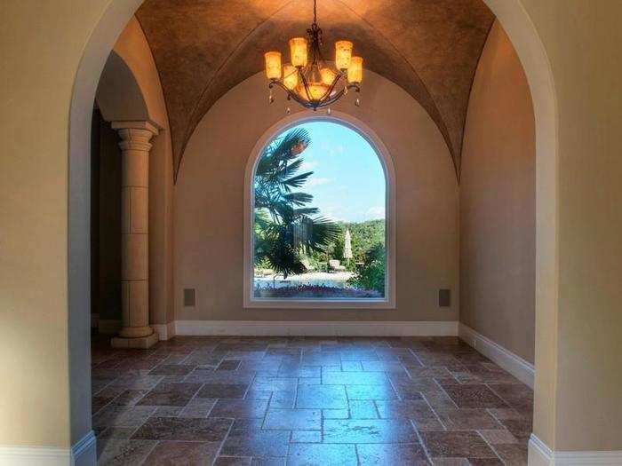 The foyer area with a stone column and great view outside through the huge window.