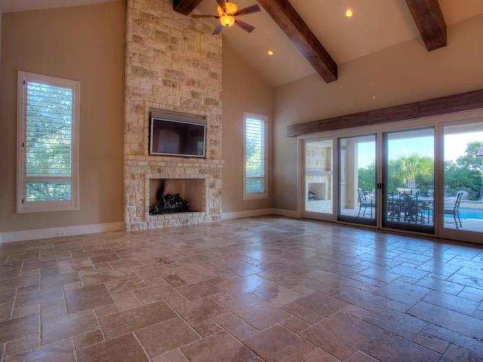 The huge family area with vaulted ceilings and a fireplace.