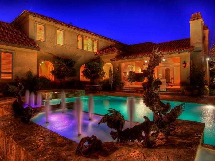 The pool lights up at night with some cool water fountains.