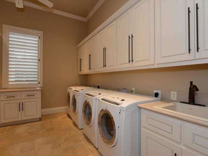 The laundry room with four washing machines.