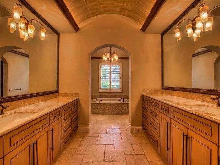 One of the very spacious bathrooms with a sink on either side leading up to the jacuzzi tub.