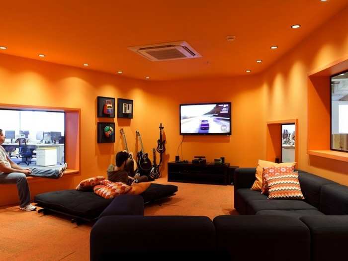 The orange floor has a lounge and video game station in its center.