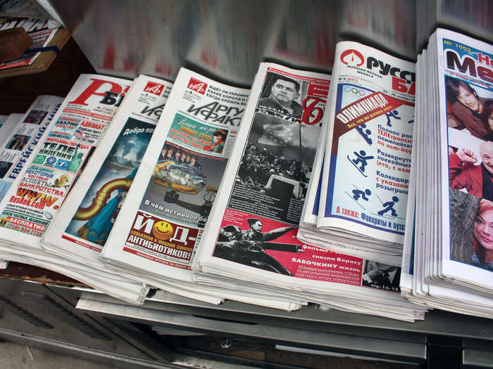 The newspapers and tabloids are in Cyrillic, an alphabetic writing system employed across Slavic languages.