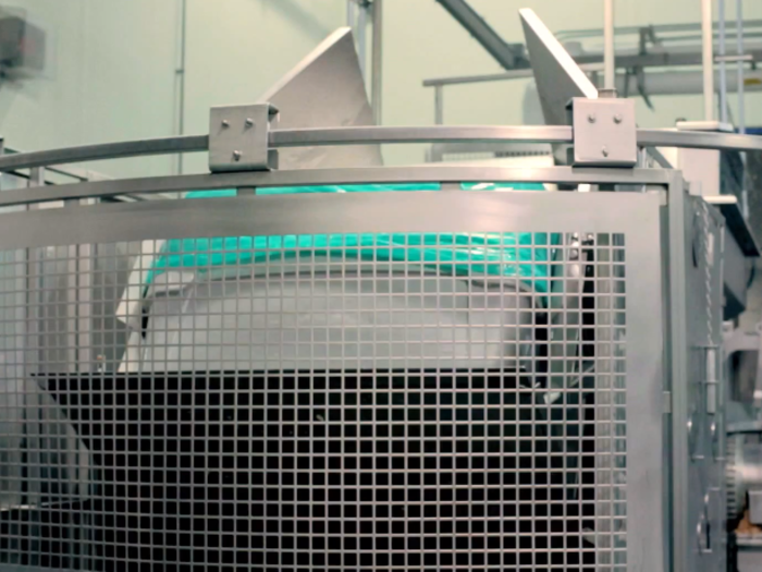 Inside the blending room, the cart of chicken breasts is lifted off the ground.