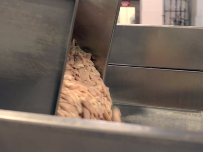 The meat is then dumped into the grinder.