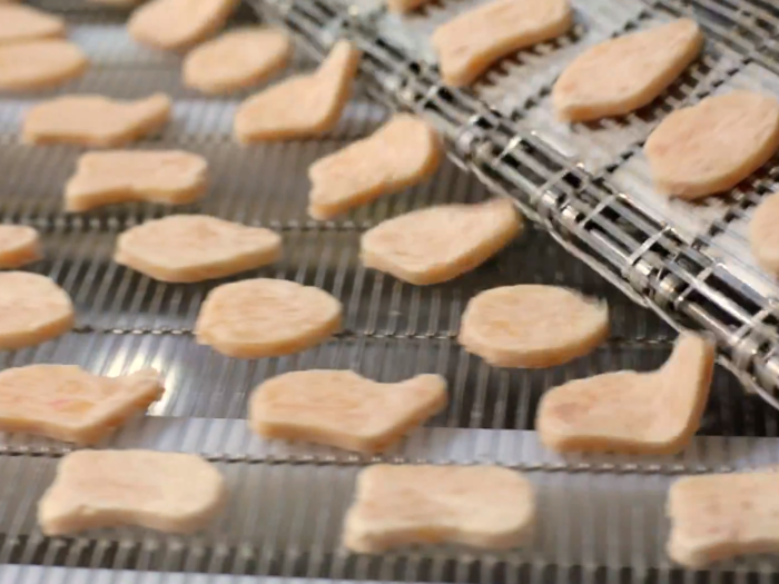 In the "forming room," the blended chicken meat is portioned into the four chicken McNugget shapes: The ball, the bell, the boot, and the bow tie.