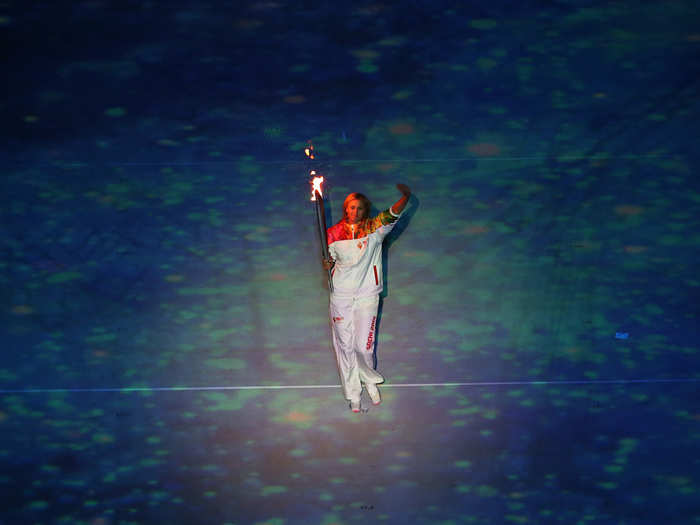 Maria Sharapova carrying the Olympic torch.