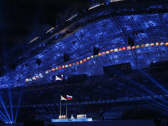 The roof of Fisht Stadium illuminated blue.