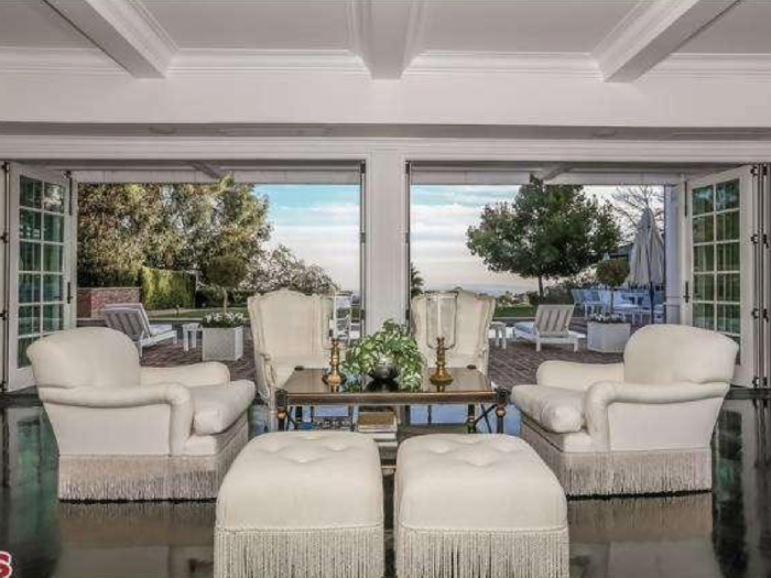 In the living room are French doors that open out to the backyard.