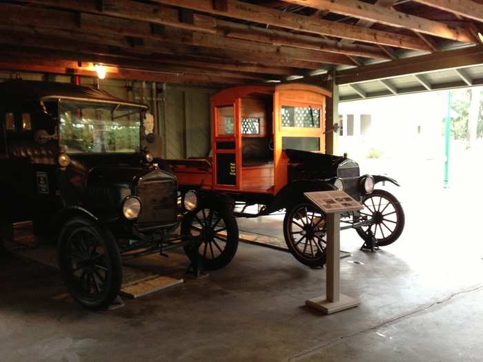 Historic Ford vehicles are displayed in a garage. This building was added to the property by the Biggar Family after it was purchased from Ford in 1945.