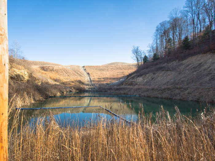 Though the Millers managed to retain their family land, it sits within sight of this sediment pond filled with mining runoff, and the family now only meets here for gatherings and events.