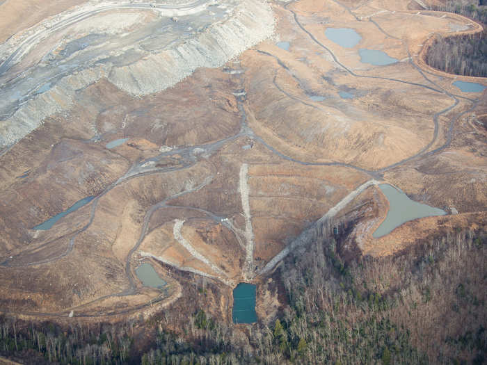 That sediment pond (bottom) is the final stop for chemical-filled water used in mountaintop removal mining. The cleared land has all been mined and shaped to induce drainage.