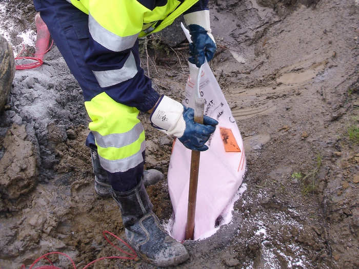 Once the homes are gone, miners bring in the blasting agent ammonium nitrate/fuel oil (ANFO), poured into large holes drilled in the ground.