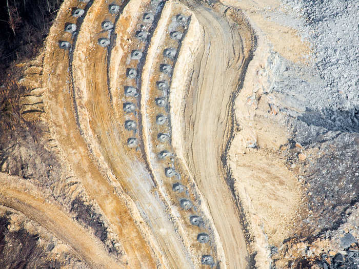 Once the ANFO is in place within a series of holes like this seen here, it is detonated. The ANFO residue, silica, coal, and rock dust then burst into the air, where it can fill communities miles away before settling to a coat of dust.