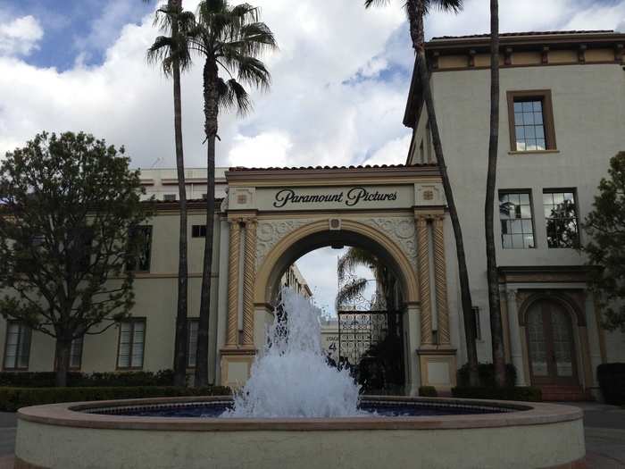 Inside the gates, visitors are greeted by water fountains and palm trees.