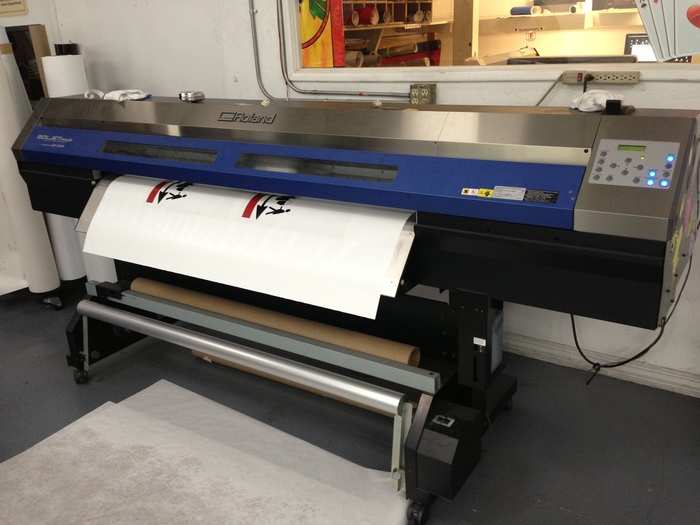 This special printer can print on any material, including a 2-inch wood door. The ink dries immediately.