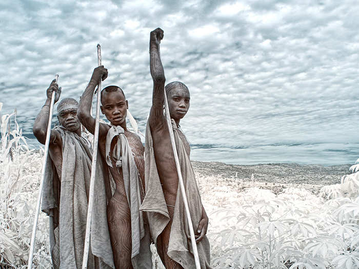 Young men from the Kara Tribe in Omo, Ethiopia stand for a portrait.