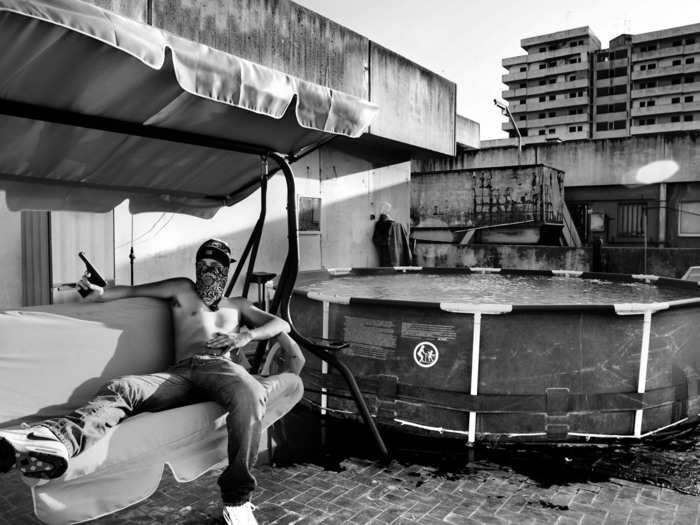 A drug pusher carries a gun in the mafia-controlled Forcella neighborhood of Naples.