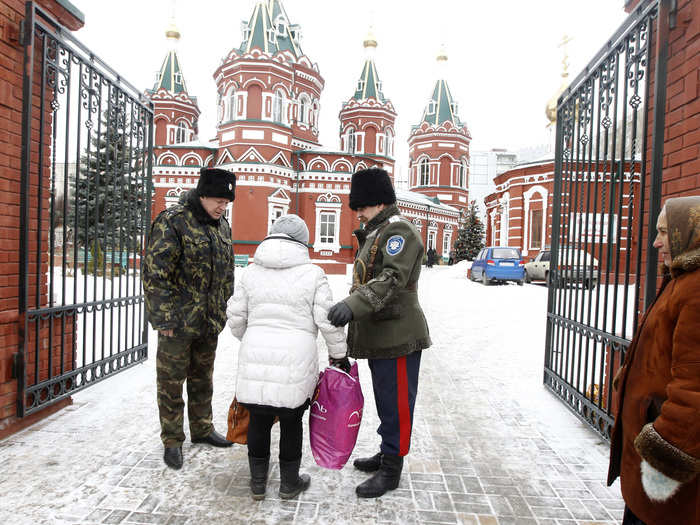 Cossacks have also been stepping up patrols throughout the Caucasus in response to the deteriorating security situation. Here, two Cossacks check a woman