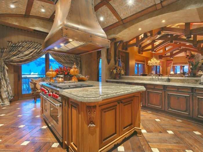 The gourmet kitchen is equipped with Wolf appliances with a large central island.