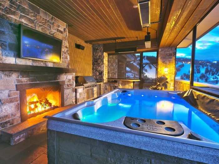 Another major selling point is the enclosed hot tub, with incredible views, a TV, and a fireplace.