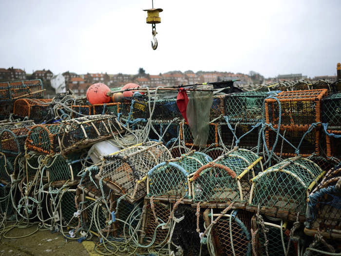 WHITBY HARBOR NOW: The port is now quiet, flanked by empty pots, nets, and dried-out fishing boats as global warming has pushed fish stocks northward. Only about 200 fishermen remain in Whitby.