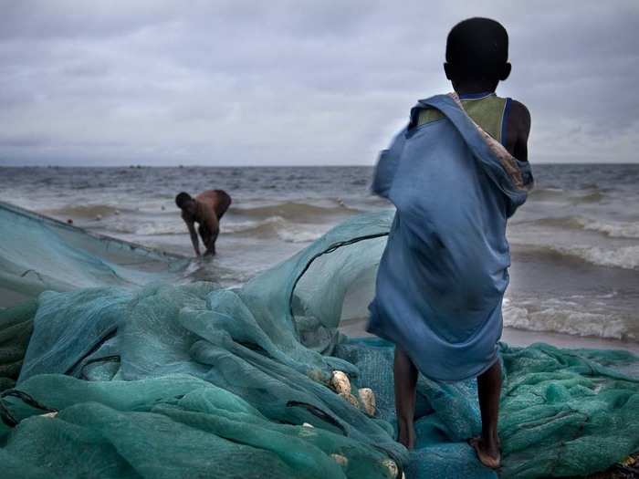 In Ghana, Kristine encountered children hauling in 1,000-pound fishing nets after all-night exhibitions.