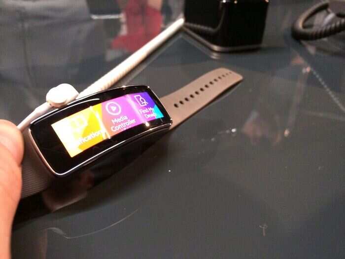 The curved display slips in and out of a watch-like wrist band, so it fits snug against your skin.