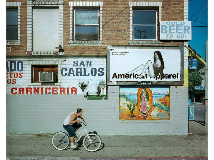 I waited almost a year for an ad to pop up in this location. I photographed homeless men limping down that sidewalk and grandfathers chasing toddlers beneath the sign. This image however, was my favorite.