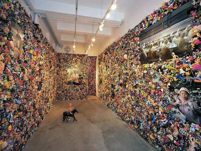 Michael Wolf, the photographer of this series, has a display made out of 16,000 toys purchased second-hand from flea markets and stores across California. Each toy has a face and was 