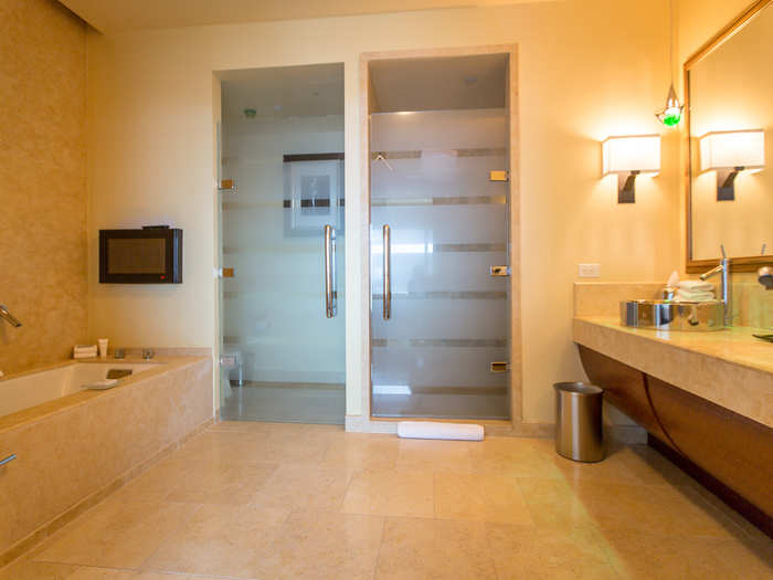 This bathroom is not quite as nice as the master bath, but it has a tub, a steam shower, and his and hers sinks.