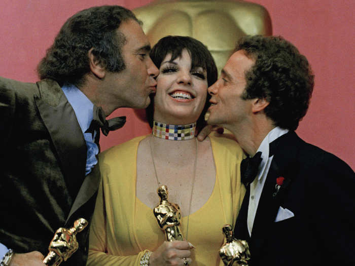 Liza Minnelli accepted kisses from fellow winners Albert S. Ruddy, producer of "The Godfather," (left) and her "Cabaret" co-star Joel Grey in 