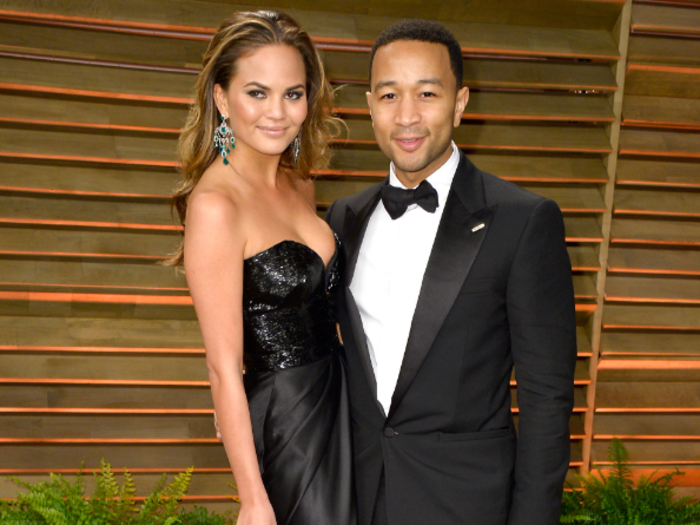 Chrissy Teigen ditched her Monique Lhullier princess gown at the Oscars and opted for a sleeker black after party dress. She kept date John Legend for both events.