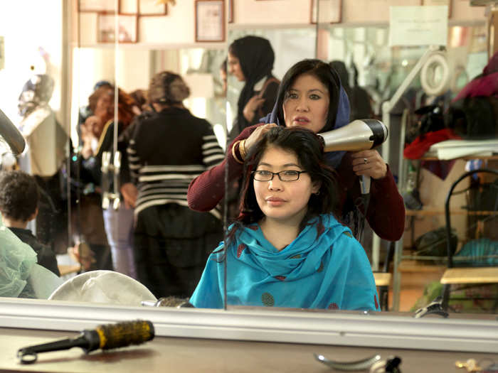 Khatera works in a beauty salon, her favorite place, which only women are allowed to frequent. Most women dye their hair black and a few get red highlights, which she says is "trendy" right now.