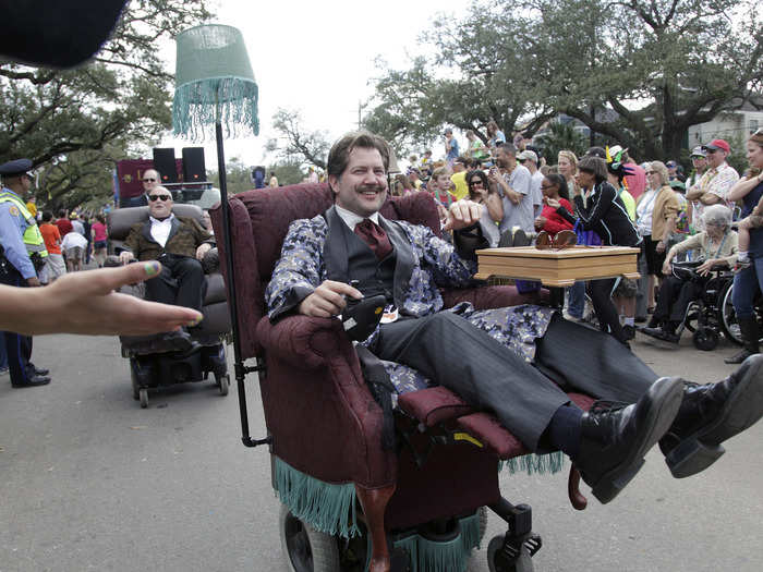 A group of men dressed as classic Southern gentlemen rode their motorized recliners down the street in the Tucks Mardi Gras parade.