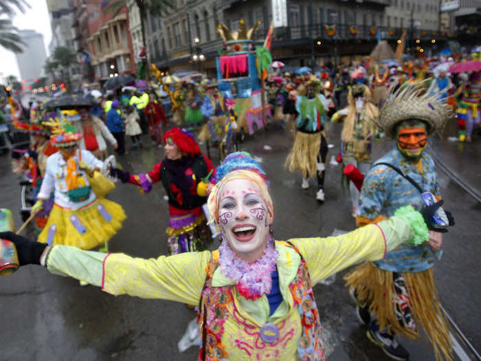 Despite the rain on Fat Tuesday, these revelers are marching through downtown New Orleans without umbrellas.