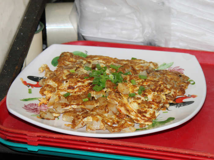 This Chinese seafood omelette is topped with chopped scallions.