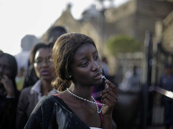 In December, former South African President Nelson Mandela passed away. Thousands flocked to see his body before his funeral. Here, a woman reacts in disappointment after access was closed on the third day of Mandela