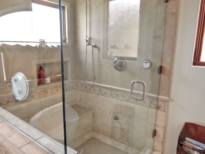 It features a walk-in steam shower.