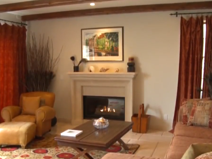 The lower level features a living area with a fireplace.