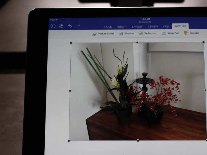 Inserting an image in Word for iPad is easy. It uses photos from your Camera Roll, and you can drag the boxes to make your picture smaller or bigger.