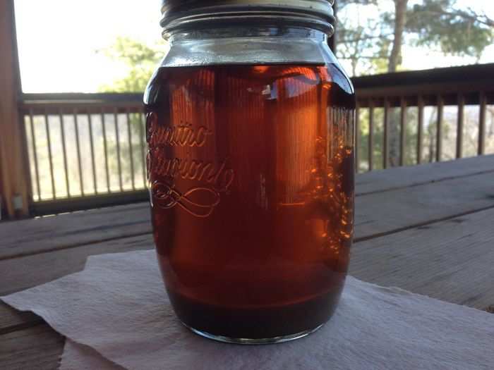 We left our syrup sitting on our porch for a week. And all those particles settled to the bottom. Then we decanted it.