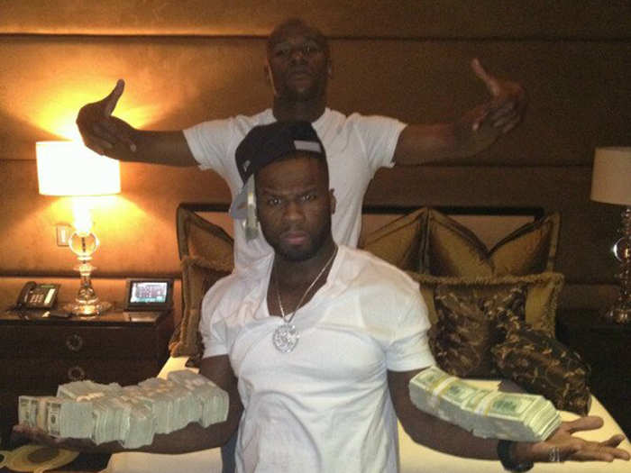 He hung out with 50 Cent, who balanced what looks like $400,000 on his forearms.