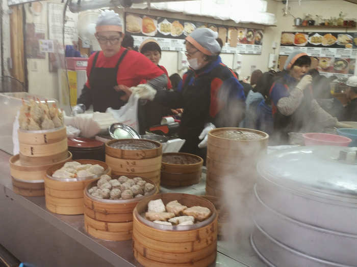 This stand was packed with people munching on platters of dumplings.